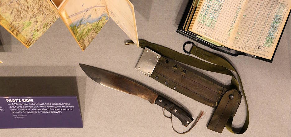 March 1, 2020 - Seen from above in its Hampton Roads Naval Museum's display case alongside maps and flight logs from other pilots assigned to missions over Vietnam is retired naval aviator Jim Reid's custom-made survival knife and sheath that he carried on all his combat missions over Vietnam. (U.S. Navy photo by Clay Farrington)