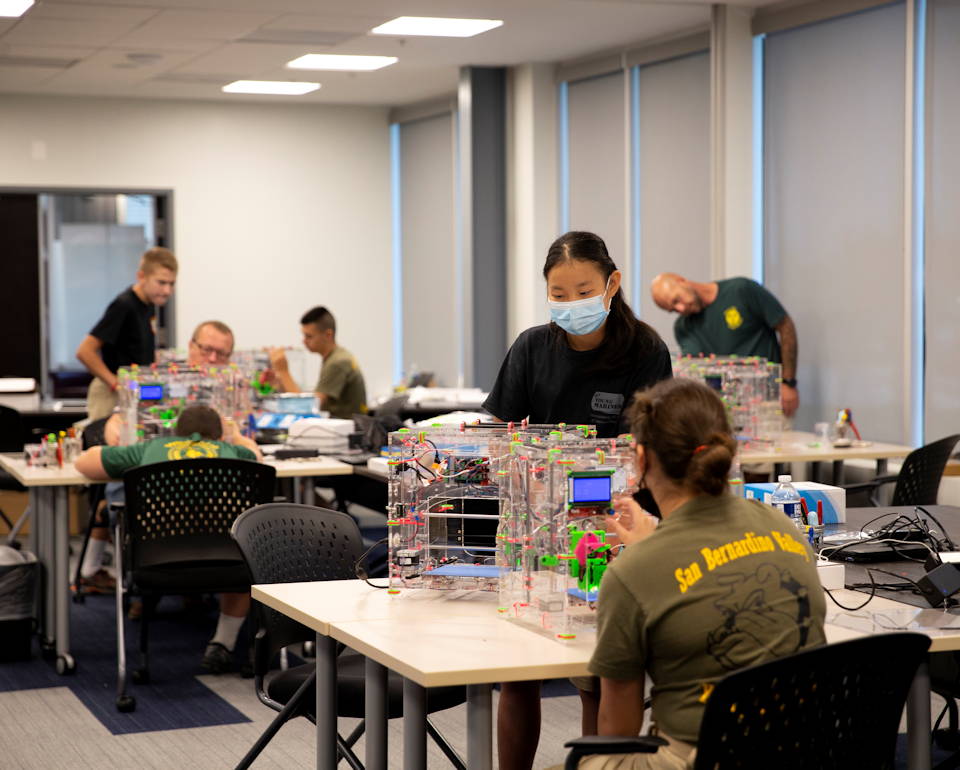 Members of the Young Marines build and operate a 3D printer during the third annual Young Marines Cyber Paths Summer Camps at the Quantico Cyber Hub, Triangle, Virginia, July 28, 2021. The Cyber Bytes Foundation, in partnership with the Deputy Commandant for Information (DC I) and the Young Marines Organization, hosted a series of five camps in programming, robotics, 3D printing, drone operations, and cyber security. The partnership enables cyber professionals the ability to serve as mentors throughout the five camps, introducing the youth of today to cyber in a meaningful and interactive way. (U.S. Marine Corps photo by Lance Cpl. Kedrick Schumacher)