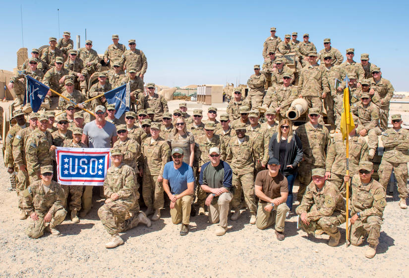 Grammy�-nominated megastar Trace Adkins Trace Adkins with U.S. Army soldiers in front of their tanks during his USO Tour 2015 in April. (Photo courtesy of the USO)