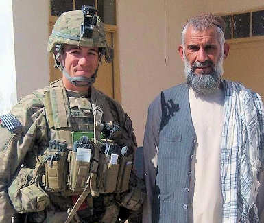 First Lt. Nicholas Vogt, platoon leader with the 1st Battalion, 5th Infantry Regiment, 1st Stryker Brigade Combat Team, 25th Infantry Division, stands next to a village elder during a mission in Kandahar province, Afghanistan on Oct. 1, 2011. Courtesy Photo