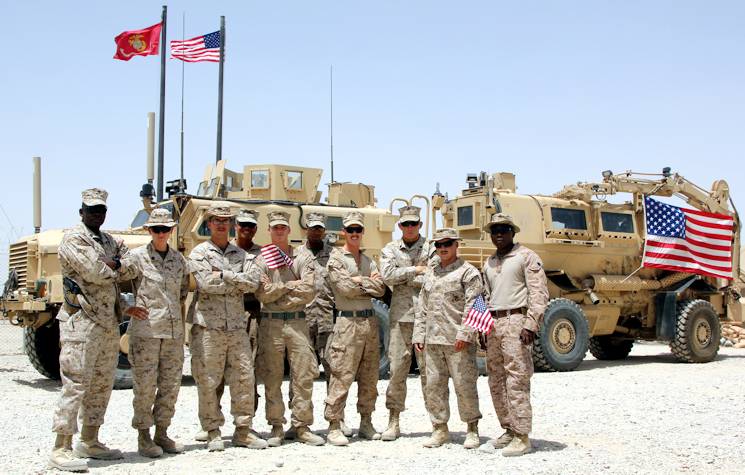 U.S. Marines with Redeployment and Retrograde in support of Reset and Reconstitution Operations Group pose for a photo on the Fourth of July aboard Camp Leatherneck, Helmand province, Afghanistan. U.S. service members throughout Regional Command (Southwest) gathered with their units to honor Independence Day while deployed to Afghanistan, July 4, 2014. (U.S. Marine Corps photo by 1st Lt. Garth Langley)